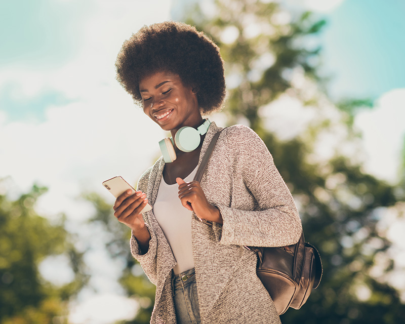 Black woman with a phone making an appointment for nurse coaching