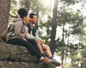 couple sitting on a rock in the woods