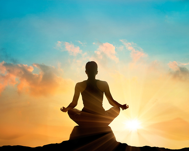 Woman in lotus position practicing yoga